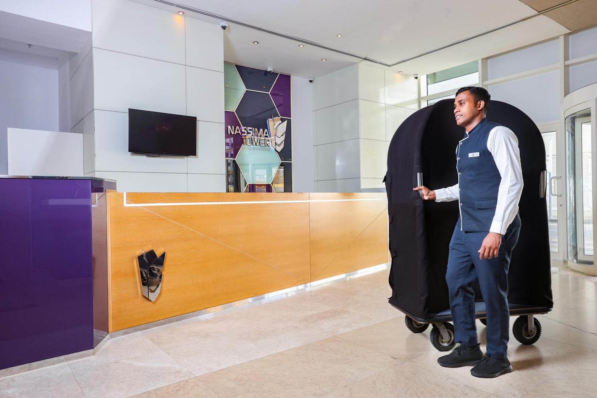 Nassima Tower Hotel Apartments Dubai Eksteriør bilde A bellboy with a luggage cart